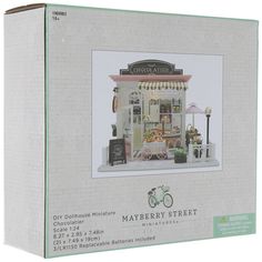 a box with a doll house on the front and inside of it, including a bicycle