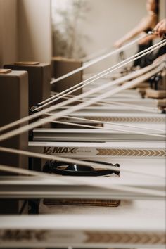 there are many pairs of skis on the conveyor belt in this storeroom