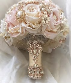 a bridal bouquet with pink roses and pearls