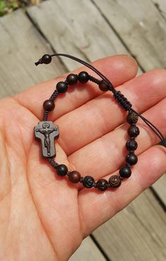 +.God Bless You. +. This is a Wooden Rosary Bracelet. +. It is knotted bracelet and it is adjustable . +. The crufix is carved in elevorate and three dementional shape. +. Beads are more beautiful because they are carved with jujube trees. +.+.+.+.+. Materials +.+.+.+.+.+. Cross: Mpingo (African black wood) beads : jujube tree carved rose wood +.+.+.+.+. Size +.+.+.+.+. Cross : 12mm(Width) *18mm(Height) Beads: 6mm +. Carved characters(e.g. baptismal name, name,etc) on back side +. please send me Adjustable Crucifix Spiritual Bracelet, Adjustable Wooden Beads Spiritual Rosary, Adjustable Crucifix Jewelry With Wooden Beads, Adjustable Wooden Beads Rosary Bracelet Gift, Adjustable Wooden Bead Rosary Bracelet Gift, Adjustable Wooden Bead Crucifix Jewelry, Spiritual Brown Rosary Bracelet With Cross, Gift Rosary Bracelet With 8mm Beads And Crucifix, Jujube Tree