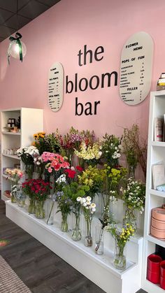 the bloom bar is filled with flowers and plants