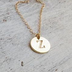 Custom Initial Necklace, hand stamped disc for your choice. Very delicate, simple and dainty necklace.A special gold initial disc connected to 14 K gold filled chain . Great idea gift for anniversary, Mother's Jewelry, best Friends, sister and co. Special holiday gift for someone you LOVE;) ****Please specify your letter in the "note to seller"  box before checkout***Necklace  Measures Approximately 17"Made from 14k gold filled or sterling silver.Initial disc Measures Approximately 0.4"If you wo Adjustable Gold Hand Stamped Charm Necklaces, Adjustable Hand Stamped Gold Charm Necklaces, Gold Hand Stamped Name Necklace For Gift, Gold Hand Stamped Name Necklace As Gift, Hand Stamped Initial Pendant Necklace, Simple Round Pendant Initial Necklace As Gift, Simple Gold Initial Necklace With Round Pendant, Gold Sterling Silver Hand Stamped Charm Necklaces, Gold Hand Stamped Round Pendant Necklace