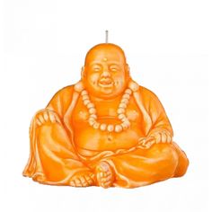 an orange buddha candle with beads around it's neck and hands in front of a white background