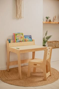 a child's wooden table and chair with books on the shelf next to it