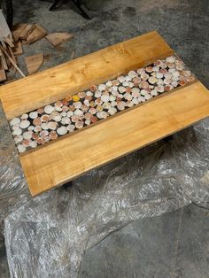 a wooden table topped with lots of shells