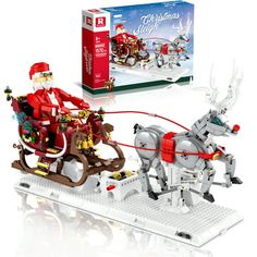 a lego christmas sleigh with santa riding in it and reindeer pulling the sleigh