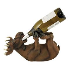 a statue of a dinosaur holding a wine bottle in it's mouth with its tongue out