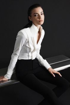 Introducing our shirt, the epitome of luxury and elegance. Made with premium quality cotton, it features a flattering bodycon fit and sophisticated cuff sleeves. Experience the ultimate comfort and style with this timeless piece, perfect for any occasion. Luxury Long Sleeve Blouse With Hidden Buttons, Elegant Long Sleeve Shirt With Button Cuffs, Luxury Long Sleeve White Blouse, Luxury Fitted Blouse With 3/4 Sleeve, White Long Sleeve Luxury Dress Shirt, Cuff Sleeves, Special Features, Slim Legs, Mandarin Collar