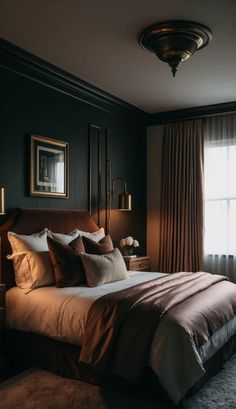 a bedroom with dark walls and brown bedding, two lamps on either side of the bed