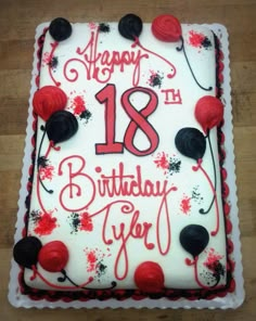 the birthday cake is decorated with red and black icing