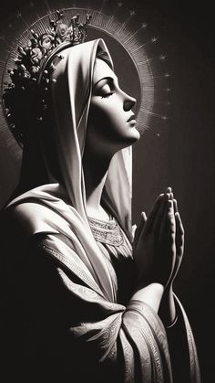 black and white image of the virgin mary with her hands clasped in front of her face