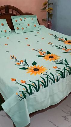 a bed with yellow flowers and green leaves on it