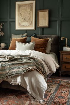 a large bed sitting on top of a wooden floor next to a wall with pictures above it