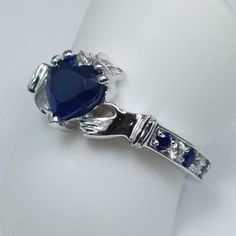 Claddagh Heart Blue Sapphire and diamonds Ring In 14K White Gold, Irish Celtic Band Center Stone: Shape: Heart Shape Carat Weight: Approx. 0.96 Color, Clarity: Medium Blue, Eye Clean Measurements: Approx. 6 x 6mm Side Stones Shape: Round Cut Diamonds & Sapphires Color, Clarity: G-H, VS-SI 100% natural diamonds & Medum Blue, Eye Clean (sapphires) Carat Weight: 0.10ct + 0.06 = 0.16ct Setting Metal: 14K White Gold Ring Size: 6.25; Free sizing from 4-8 Return Policy: 100% satisfaction guaran Sapphire Heart Ring, Irish Ring, Celtic Band, Irish Rings, Claddagh Rings, Diamond Bridal Sets, Irish Celtic, Sapphire Color, Diamonds Ring