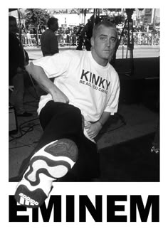 a black and white photo of a man sitting on a bench with his skateboard