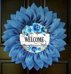 a blue wreath with the words welcome on it