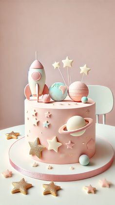 a pink cake with stars and planets on it