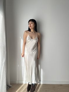 Vintage liquid silk satin backless white slip long maxi camisole dress with lace back cross design, you can wear it as a summer silk slip dress or night party dress.  era: 1990, 2000, Y2K material:100% pure silk Size: around S, Model wears size S, 36 Full length 125cm pit to pit: 36cm waist: 35cm condition: very good condition Please keep in mind that this is vintage second hand piece. It may have small marks and/or snags and sign of wear throughout. Please purchase willing to accept all signs o White Satin Cami Slip Dress, Silk Cami Slip Dress With Bias Cut, White Satin Nightgown With Spaghetti Straps, White Backless Bias Cut Maxi Dress, White Fitted Slip Dress For Night, Fitted Silk Nightgown With Spaghetti Straps, Spring Bias-cut Slip Dress For Wedding Night, Spring Bias Cut Slip Dress For Wedding Night, White Satin Backless Slip Dress