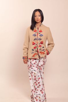 "Beige wool jacket with floral embroidery and natural silk lining. Embellished with Swarovski crystals. Each jacket is hand embroidered and one of a kind. Collection \"MOON [mo:n]\" is inspired by floral embroidery from Muhu, a small island in Estonia with great handicraft traditions.  Each flower, bird and animal embroidered on the jacket has their own symbolic meaning. This jacket will be made especially for you and according to your measurements. Please allow 2-4  weeks for creating it. We sh Beige Floral Embroidered Outerwear For Fall, Fall Beige Outerwear With Floral Embroidery, Embellished Long Sleeve Silk Outerwear, Beige Floral Embroidered Winter Outerwear, Beige Winter Outerwear With Floral Embroidery, Embroidered Long Sleeve Silk Outerwear, Silk Outerwear With Intricate Embroidery For Spring, Traditional Floral Print Outerwear For Spring, Traditional Floral Print Spring Outerwear