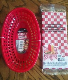 a red basket sitting next to a packaged package