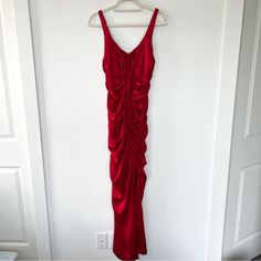 a red dress hanging on a white wall