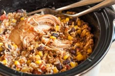 a slow cooker filled with rice, beans and corn