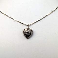 "This antiqued sterling silver, two-sided, repousse Puffy heart Charm Number 33 features an American flag framed by an heart. Marked, Sterling. Made by Brown County Silver. Vintage and in new, never worn condition. Approximately 30 years old. Small: 5/8\" high with jump ring 3/8\" wide 0.7 grams Medium: 7/8\" high with jump ring 5/8\" wide 1.4 grams *Chain sold separately See more @ https://www.etsy.com/shop/brocosi" Silver Heart Necklace For Commemoration, Sterling Silver Heart Jewelry With Heart Beads, Heart-shaped Etched Jewelry For Keepsake, Silver Jewelry For Valentine's Day Commemoration, Heart-shaped Etched Keepsake Jewelry, Keepsake Heart-shaped Etched Jewelry, Sterling Silver Nickel-free Heart Necklace Keepsake, Sterling Silver Nickel-free Heart Necklace For Keepsake, Etched Heart Silver Jewelry