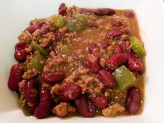 a white bowl filled with chili and beans