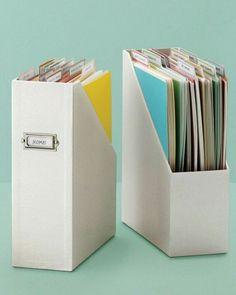 two white file cabinets filled with files and folders next to each other on a green surface