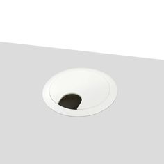 a white toilet bowl cover with a hole in the middle on a gray flooring area