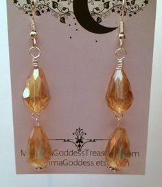 "Gorgeous faceted tear drop gold crystals in a double drop style will move and sparkle all though the night. Plan to draw eyes to your ears all evening. These earrings hang 2.5\" in length from ear wires. Do let me know if you prefer posts or need clips. Great gift for your special friend or for yourself." Dangle Wire Wrapped Crystal Earrings For Party, Wire Wrapped Teardrop Chandelier Earrings For Party, Wire-wrapped Teardrop Chandelier Earrings For Parties, Teardrop Crystal Earrings With Faceted Beads, Teardrop Wire Wrapped Chandelier Earrings For Parties, Gold Faceted Dangle Chandelier Earrings, Gold Dangle Drop Earrings For Party, Gold Faceted Chandelier Dangle Earrings, Wire Wrapped Teardrop Earrings For Party