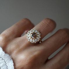 a woman's hand with a diamond ring on it