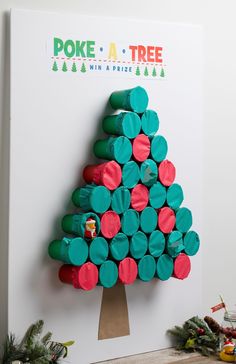 a christmas tree made out of toilet paper rolls is displayed on a white board with the words poke - a - tree above it