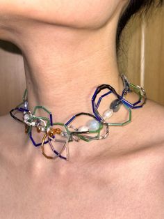 a woman wearing a multicolored necklace on her neck