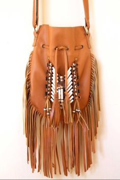 Boho style handmade leather bag. Handcrafted bone bead and natural coconut bead embellishment choker attached as decoration Fully lined inside with one pocket. The adjustable leather shoulder strap fits either across the body or slung over your shoulder. Material: leather, bones,coconut beads 8.2 in wide, 11.4 in long. total long include feather fringes 18.9 in approx 21 cm wide,29 cm long. total long include leather fringes 48 cm approx available color: tan Best finishing quality Please note th Bohemian Leather Hobo Bag With Tassels, Bohemian Leather Shoulder Bag With Fringe, Artisan Brown Bag With Fringe, Brown Artisan Bags With Fringe, Artisan Brown Bags With Fringe, Bohemian Brown Shoulder Bag With Fringe, Festival Brown Hobo Bag With Fringe, Brown Shoulder Bag With Tassels For Festival, Brown Fringe Hobo Bag For Festival