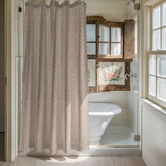 a bath room with a shower curtain and a tub