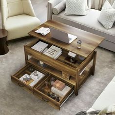 a living room filled with furniture and a laptop computer on top of a coffee table