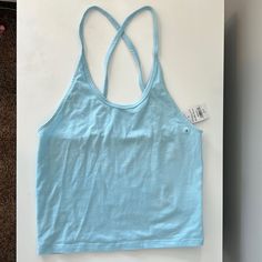 Light Blue Convertible Cami. New With No Damage. Blue Tank Top With Built-in Bra, Light Blue Sleeveless Workout Top, Versatile Yoga Tops For Spring, Versatile Spring Yoga Tops, Spring Light Blue Tank Top With Built-in Bra, Light Blue Tank Top With Built-in Bra For Spring, Blue Tops With Built-in Bra For Summer, Light Blue Spring Tops With Built-in Bra, Light Blue Tops With Built-in Bra For Spring