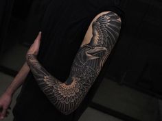 a man with a bald eagle tattoo on his arm