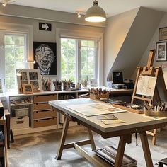 an artist's studio with lots of art supplies on the table and desks