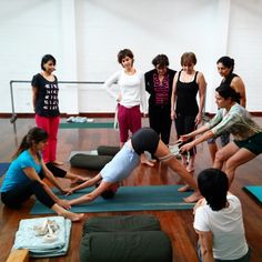 a group of people doing yoga on mats