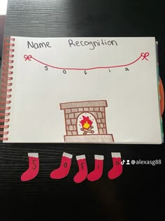 there is a note book with a drawing of a fireplace and stockings on the cover