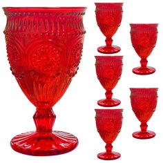 a set of red glass goblets sitting next to each other on a white background