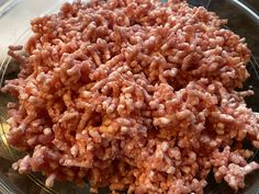 a bowl filled with meat sitting on top of a table