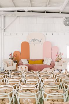 chairs and couches are lined up in front of a wall with the words inspired on it