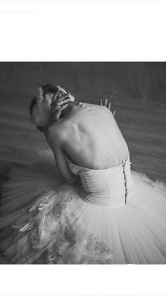 black and white photograph of a ballerina in tutu with her hands on her face