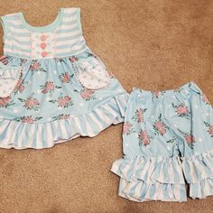 New In Package. Blue Floral Ruffle Shorts Outfit. Runs Generous To Size Marked. Top Has Pockets.. Sizes Available: 6-12 Month, 12-18 Month, 2t, 3t, 5-6, 6-7. 95% Cotton, 5% Spandex. Soft Material. Cute Ruffled Bottoms For Playwear, Cute Ruffled Bottoms For Playtime, Blue Cotton Bottoms With Ruffle Hem, Cute Blue Summer Bloomers, Spring Light Blue Ruffled Sets, Casual Blue Bloomers For Spring, Spring Blue Cotton Bloomers, Playful Blue Ruffled Bottoms, Spring Ruffled Bottoms For Playtime