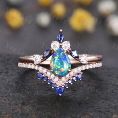 an opal and diamond ring with blue accents