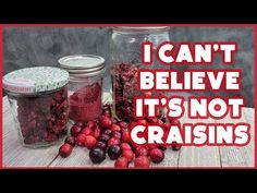 some jars filled with cherries sitting on top of a wooden table and the words i can't believe it's not craisins