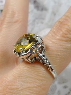 Simulated Yellow Citrine Ring Description Speechless Design#103 MADE TO ORDER Inspired by Victorian era filigree designs, I now offer this stunning Antique inspired ring in sterling silver. This fabulous ring is set with a 6ct flawless Man-made/Simulated citrine gemstone. The round full cut high-quality blue gemstone is 12mm (just shy of 1/2th of an inch) in diameter. The inside of the band is marked 925 for sterling. Notice the beautiful intricate bow and floral-like design of the silver filigr Victorian Gold Citrine Jewelry, Hallmarked Citrine Rings, Victorian Rings Vintage, Antique Silver Citrine Jewelry, Victorian Hallmarked Citrine Jewelry, Luxury Silver Citrine Crystal Ring, Yellow Citrine Ring, Victorian Filigree, Victorian Ring